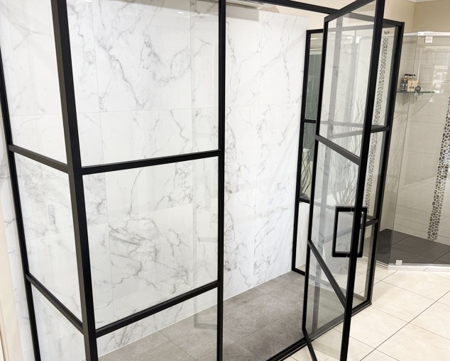 Frameless New York style shower screen Canberra Canberra bathroom featuring a New York-style shower screen with a slim black frame, showcasing modern industrial bathroom design and premium shower screen installation.