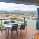 Retractable fly screen on open bifold doors in a Canberra home in summer