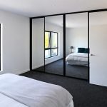 Custom mirrored sliding wardrobe doors installed in a Canberra bedroom by Monaro Screens